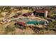 Aerial view showcasing a community pool with waterslides and a splash park, perfect for Gathering fun at 21682 E Stroll Ave, Parker, CO 80138