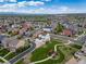 Wide aerial shot of a community featuring homes, streets, and a park with walking paths at 21682 E Stroll Ave, Parker, CO 80138
