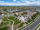 Panoramic aerial view of a neighborhood showcasing various home styles and community green spaces at 21682 E Stroll Ave, Parker, CO 80138