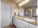 Well-lit bathroom featuring dual sinks with granite countertops, and tile flooring at 21682 E Stroll Ave, Parker, CO 80138