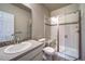 Well-lit bathroom with glass shower, single sink and vanity at 21682 E Stroll Ave, Parker, CO 80138