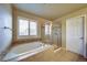 Bright bathroom featuring a soaking tub, a separate shower, and decorative tile accents at 21682 E Stroll Ave, Parker, CO 80138