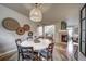 Open concept dining room with decorative wall baskets and views to the fireplace and living room at 21682 E Stroll Ave, Parker, CO 80138