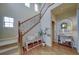 Inviting entryway with wood floors, lots of natural light, and an attractive staircase at 21682 E Stroll Ave, Parker, CO 80138