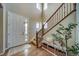 Inviting entryway with wood floors, lots of natural light, and an attractive staircase at 21682 E Stroll Ave, Parker, CO 80138