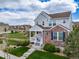 Charming two-story home with a welcoming front porch, lush lawn and beautiful landscaping at 21682 E Stroll Ave, Parker, CO 80138