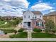 Charming two-story home with a welcoming front porch, lush lawn and beautiful landscaping at 21682 E Stroll Ave, Parker, CO 80138