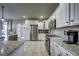 Well-equipped kitchen features stainless steel appliances, granite counters and mosaic tile backsplash at 21682 E Stroll Ave, Parker, CO 80138