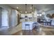 Modern kitchen features white cabinetry, granite countertops, stainless steel appliances, and eat in dining area at 21682 E Stroll Ave, Parker, CO 80138