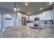 Bright kitchen features granite countertops, stainless steel appliances and plentiful cabinetry at 21682 E Stroll Ave, Parker, CO 80138