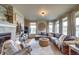 Comfortable living room featuring a corner fireplace, neutral paint, and lots of natural light at 21682 E Stroll Ave, Parker, CO 80138