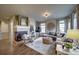 Comfortable living room featuring a corner fireplace, neutral paint, and lots of natural light at 21682 E Stroll Ave, Parker, CO 80138