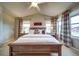 Vaulted ceiling main bedroom with king bed, decorative pillows and natural light from large windows at 21682 E Stroll Ave, Parker, CO 80138