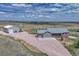 Aerial view of the house and barn with wide open land surrounding the property at 6957 Black Forest Dr, Elizabeth, CO 80107