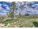 Backyard with a fence and trees with a view of another house at 6957 Black Forest Dr, Elizabeth, CO 80107