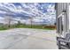 Wide angle view of a concrete patio and the spacious backyard area at 6957 Black Forest Dr, Elizabeth, CO 80107