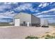 Exterior of the metal barn with a sliding door and gravel area at 6957 Black Forest Dr, Elizabeth, CO 80107