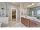 Modern bathroom with double vanity, a spacious shower, and an open walk-in closet at 6957 Black Forest Dr, Elizabeth, CO 80107