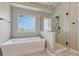 Contemporary bathroom with a soaking tub, glass-enclosed shower, and picturesque window views at 6957 Black Forest Dr, Elizabeth, CO 80107