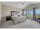 Bright bedroom featuring a tray ceiling, soft carpet, and expansive windows showcasing scenic views at 6957 Black Forest Dr, Elizabeth, CO 80107