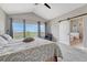 Cozy bedroom with vaulted ceiling, large windows, and an en-suite bathroom with a sliding barn door at 6957 Black Forest Dr, Elizabeth, CO 80107