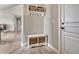 Inviting entryway with a storage bench and decorative wall shelf, offering a functional and stylish space at 6957 Black Forest Dr, Elizabeth, CO 80107