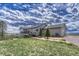 View of the back of the house, with a porch and well-kept grass at 6957 Black Forest Dr, Elizabeth, CO 80107