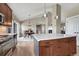 Bright kitchen with stainless steel appliances, center island, and adjacent dining area with natural light at 6957 Black Forest Dr, Elizabeth, CO 80107