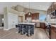 Eat-in kitchen featuring stainless steel appliances, island seating, and bright natural light at 6957 Black Forest Dr, Elizabeth, CO 80107