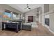 Bright living room with hardwood floors, vaulted ceilings, modern ceiling fan, and gas fireplace at 6957 Black Forest Dr, Elizabeth, CO 80107