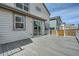 View of the back of the house and deck, with sliding glass door at 9544 Pitkin St, Commerce City, CO 80022
