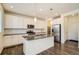 Modern kitchen featuring white cabinets, stainless steel appliances, and granite countertops at 9544 Pitkin St, Commerce City, CO 80022