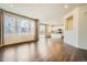 Spacious living room with hardwood floors and ample natural light, connects to the kitchen at 9544 Pitkin St, Commerce City, CO 80022