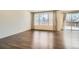 Bright living room with hardwood floors and large sliding door to an outdoor patio at 9544 Pitkin St, Commerce City, CO 80022