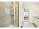 Walk-in shower featuring tile surround, glass door, and built-in niche at 9544 Pitkin St, Commerce City, CO 80022