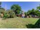 Spacious backyard with a shed, mature trees, and plenty of green space for outdoor activities at 6043 S Cody Way, Littleton, CO 80123