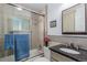 Well-lit bathroom with a shower and tub, granite vanity and brushed metal fixtures at 6043 S Cody Way, Littleton, CO 80123