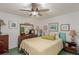 Well-lit bedroom showcasing ceiling fan, dresser, wall art, mirror, and coordinated decor at 6043 S Cody Way, Littleton, CO 80123