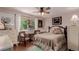 Bright bedroom with ceiling fan, large window, hardwood floors and plenty of natural light at 6043 S Cody Way, Littleton, CO 80123