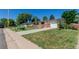 Well-maintained ranch-style home with a long driveway and lush green lawn at 6043 S Cody Way, Littleton, CO 80123