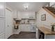 Efficient kitchen with white cabinetry, granite countertops, and updated appliances, designed for culinary convenience at 6043 S Cody Way, Littleton, CO 80123