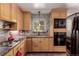 Cozy kitchen with light wood cabinets, granite countertops, and stainless steel appliances at 6043 S Cody Way, Littleton, CO 80123