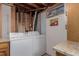Functional laundry area with side-by-side appliances, utility sink, and storage, making laundry chores easier at 6043 S Cody Way, Littleton, CO 80123