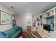 Well-lit living room with wooden floors, stylish furniture and a large window at 6043 S Cody Way, Littleton, CO 80123