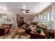 Inviting living room with hardwood floors, leather furniture, and a ceiling fan at 6043 S Cody Way, Littleton, CO 80123