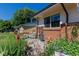 Cozy outdoor patio features a wrought iron table and chairs, surrounded by lush greenery at 6043 S Cody Way, Littleton, CO 80123