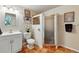 Tiled bathroom features a shower stall, decorative mirror, and modern fixtures at 8645 Coors St, Arvada, CO 80005