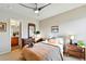 Sun-lit bedroom boasts a walk-in closet with a dressing mirror and wood furnishings at 8645 Coors St, Arvada, CO 80005
