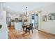 Open dining area with hardwood floors, chandelier, and sliding glass doors to outdoor patio at 8645 Coors St, Arvada, CO 80005