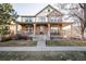 Charming two-story brick home with a welcoming front porch and well-maintained landscaping at 8645 Coors St, Arvada, CO 80005